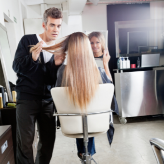 hairdresser consults with client