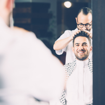 Barber looking through the mirror at his client