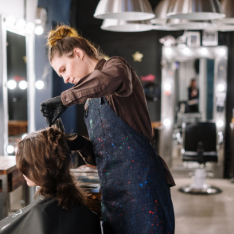 hairdresser pulling back clients hair