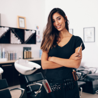 Female hairdresser standing in salon