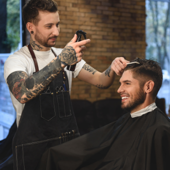 barber mists client's hair