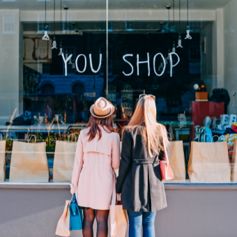 Two girls in jackets shopping retail