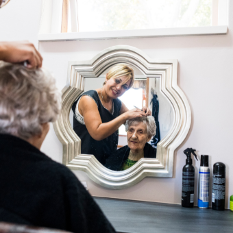 hairdresser styling clients hair