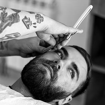 Male salon owner and AHP Affinity Partner holding scissors.