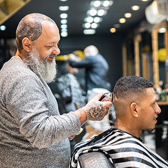 Barber and AHP Affinity Partner cutting hair