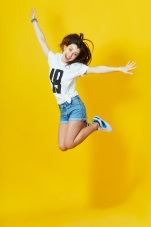 girl jumping with yellow background