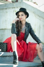 girl in a red dress with a leather jacket and hat